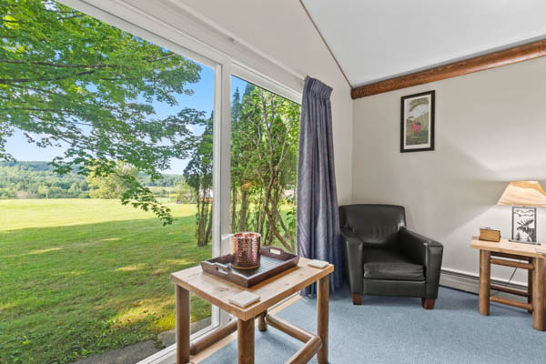 cozy chair and table with lovely lawn views