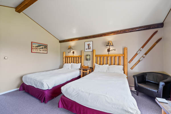room 2 features two extra long double beds (same length as a king bed) with duvet comforters. ski theme